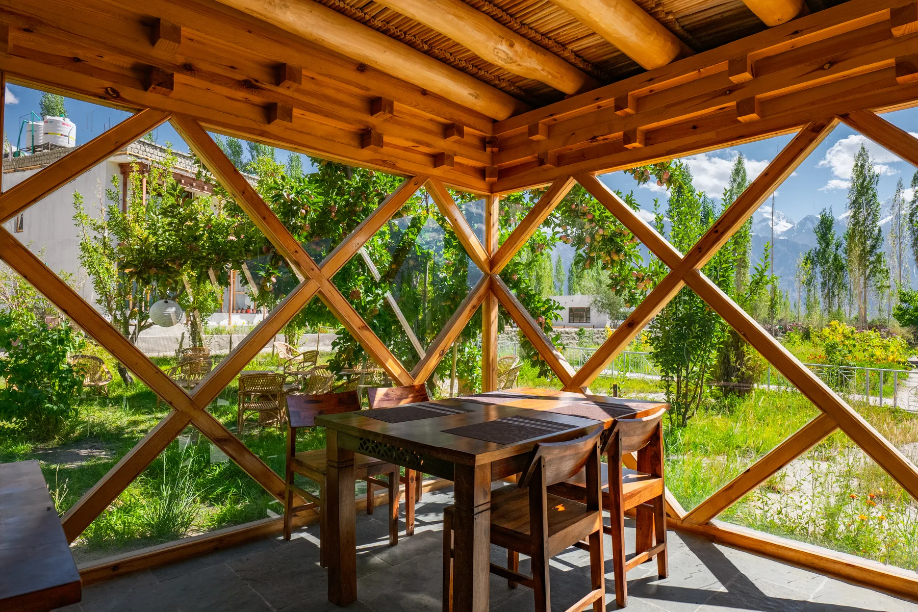 Open dining pavilion surrounded by gardens